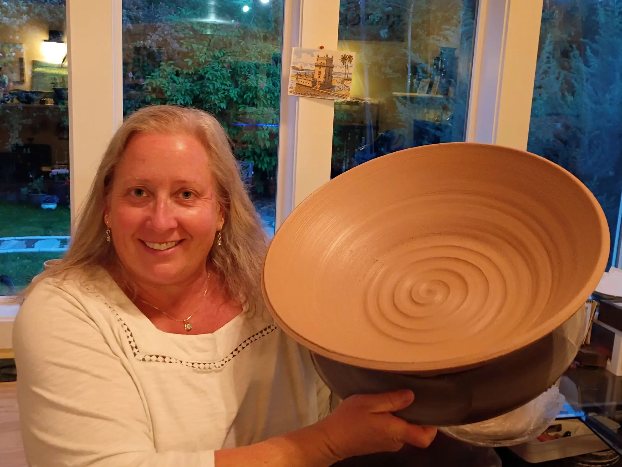 Kim Blais holding a large, freshly thrown clay bowl